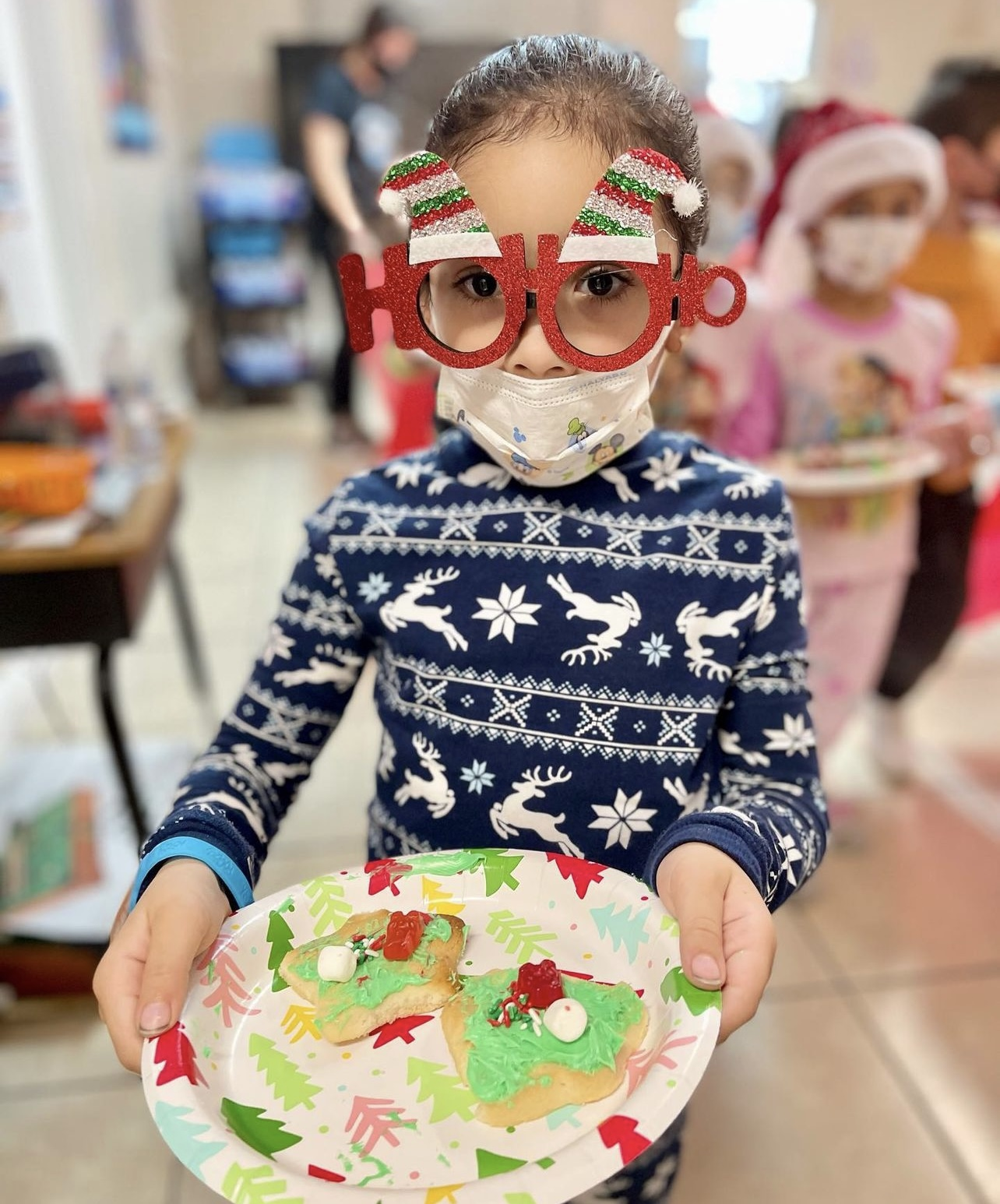 Child celebrating with holiday treats at one of our partner locations