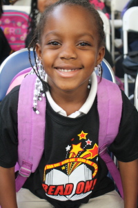 Smiling child with backpack, representing the children we serve